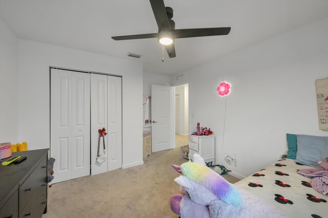 carpeted bedroom featuring a closet and ceiling fan