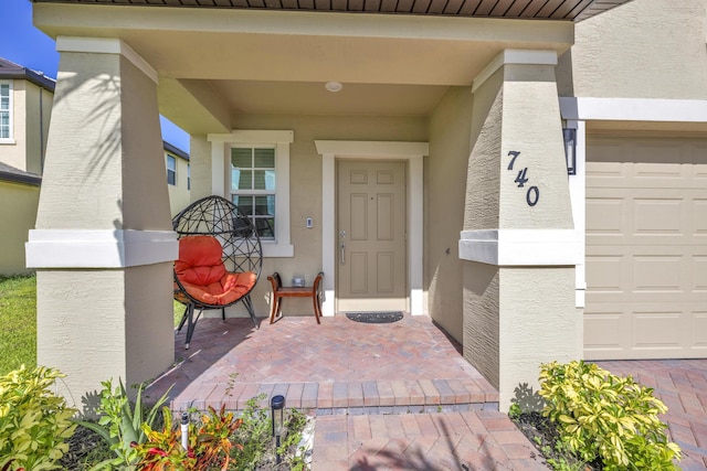 doorway to property with a garage