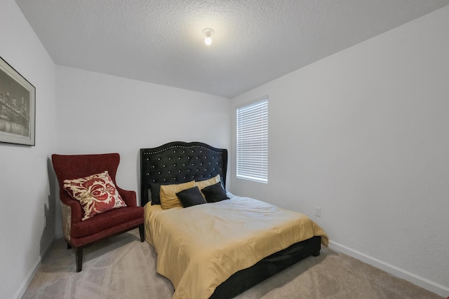 bedroom featuring carpet flooring and a textured ceiling