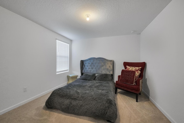 carpeted bedroom featuring a textured ceiling