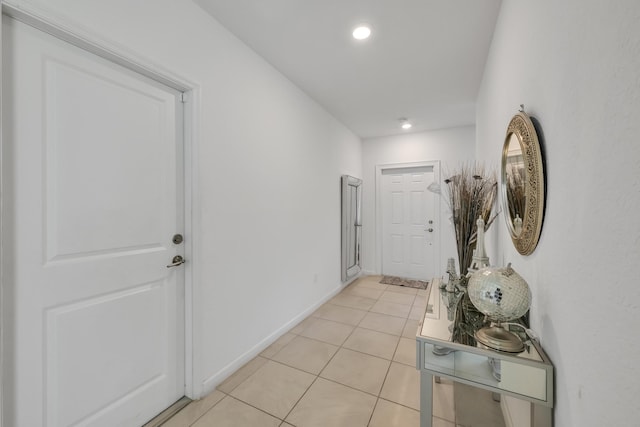 doorway to outside with light tile patterned flooring