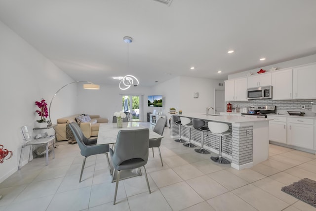 tiled dining area featuring sink