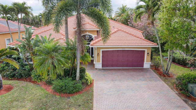 mediterranean / spanish house with a garage