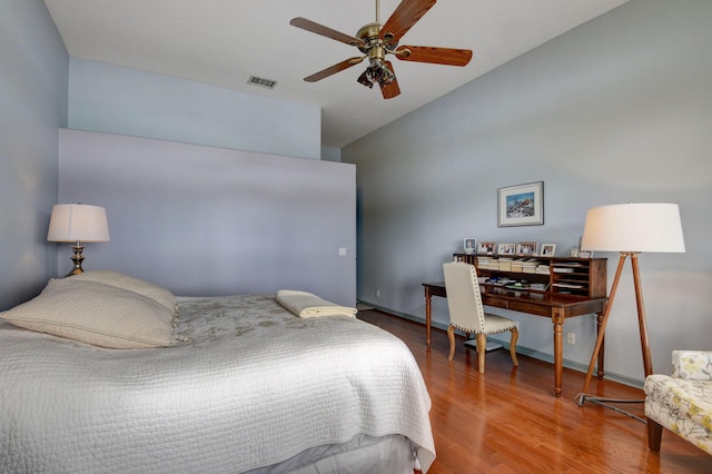 bedroom featuring hardwood / wood-style floors, ceiling fan, and lofted ceiling