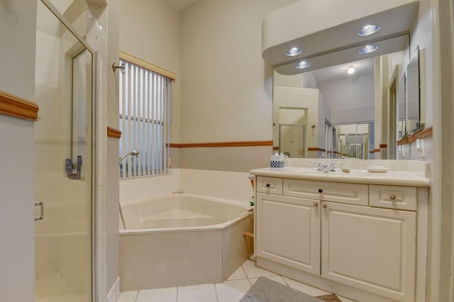 bathroom with plus walk in shower, vanity, and tile patterned floors