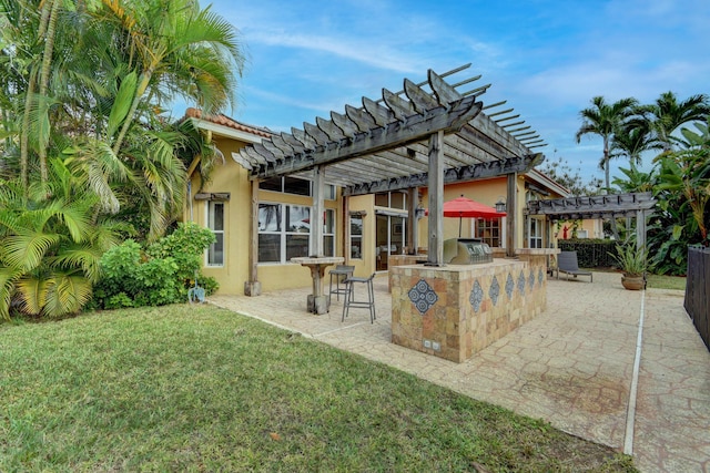 exterior space featuring a pergola, area for grilling, a patio area, and exterior bar