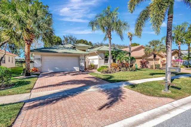 view of front of property featuring a garage and a front lawn