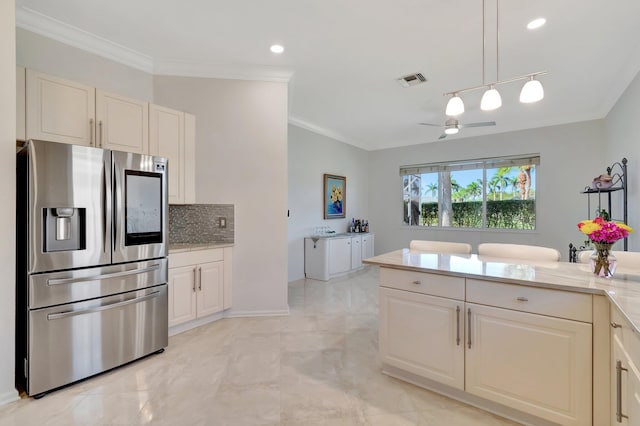 kitchen featuring decorative backsplash, stainless steel fridge, ceiling fan, ornamental molding, and decorative light fixtures