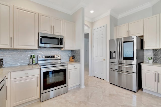 kitchen featuring appliances with stainless steel finishes, tasteful backsplash, and white cabinetry