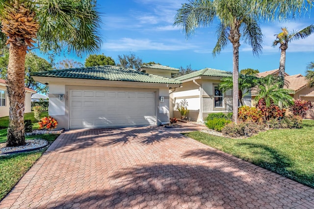 view of front of house with a front yard and a garage