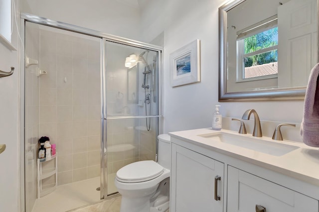 bathroom with vanity, an enclosed shower, and toilet