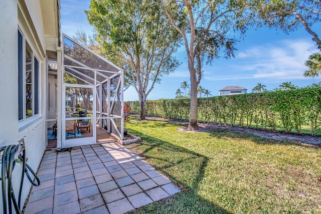 view of yard with a patio area and a lanai