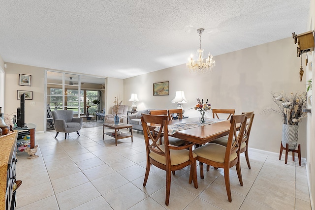 dining room with light tile patterned floors, a chandelier, and a textured ceiling