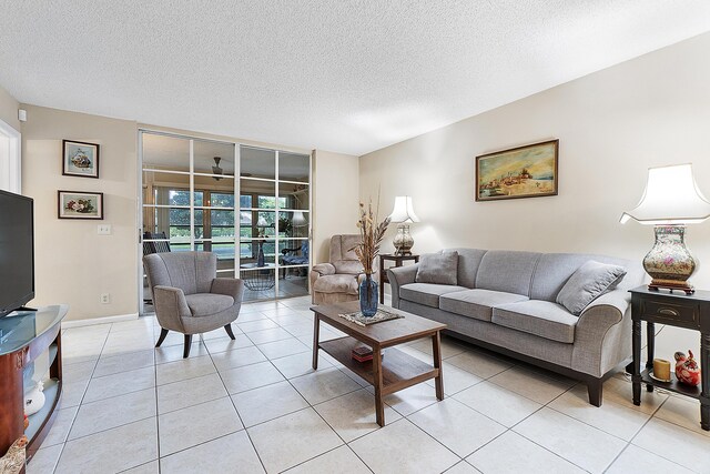 tiled living room featuring a textured ceiling