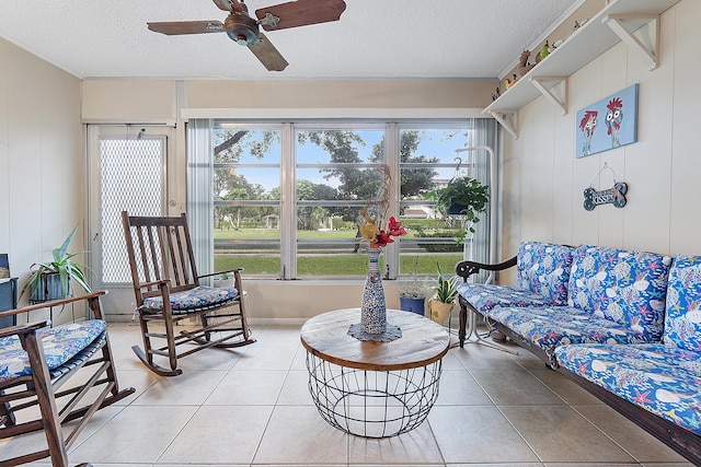 sunroom featuring ceiling fan