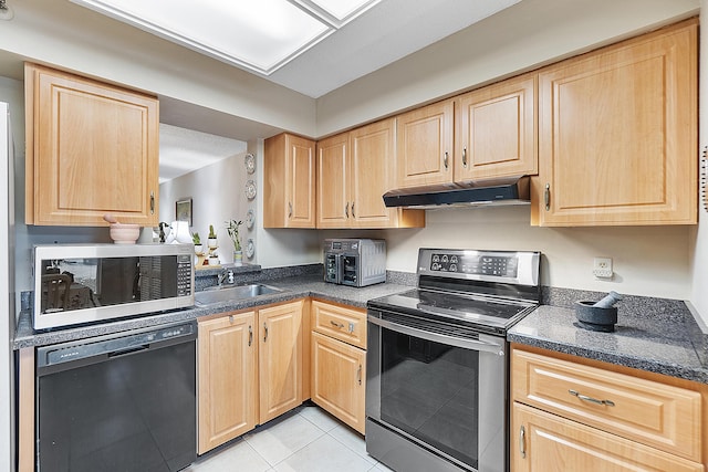 kitchen featuring light brown cabinetry, light tile patterned floors, sink, and appliances with stainless steel finishes