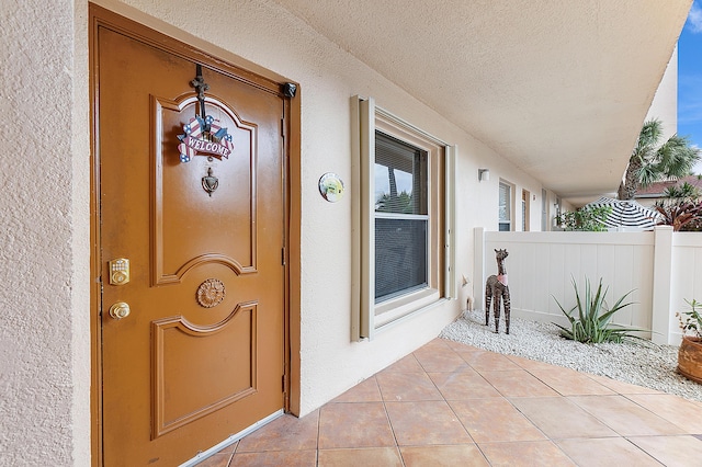 view of exterior entry with a porch