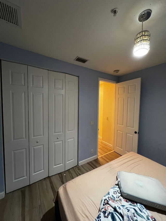 bedroom featuring a closet and hardwood / wood-style flooring