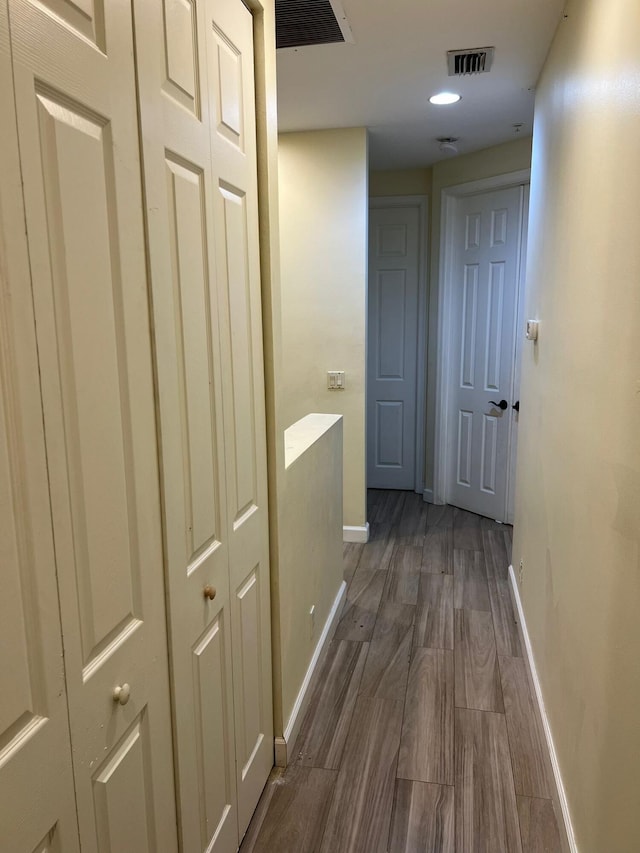 corridor with dark hardwood / wood-style flooring