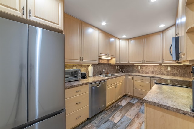 kitchen featuring backsplash, dark hardwood / wood-style floors, sink, stainless steel appliances, and light brown cabinetry