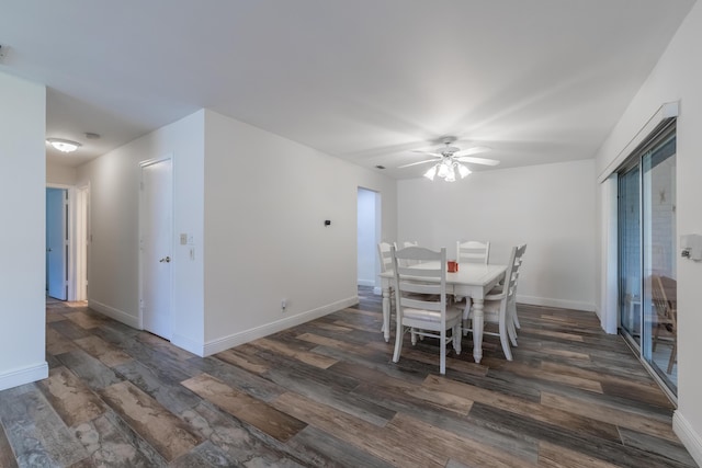 dining space with ceiling fan and dark wood-type flooring