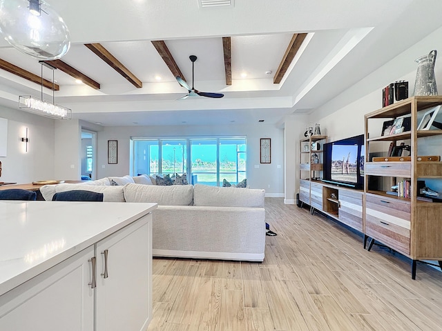 living room with beam ceiling, light hardwood / wood-style flooring, and ceiling fan