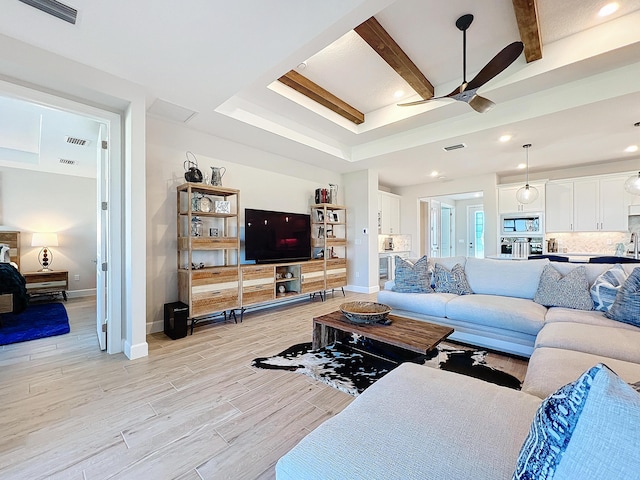 living room featuring beam ceiling and ceiling fan