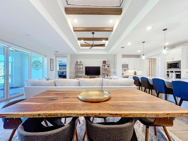 dining space featuring beam ceiling