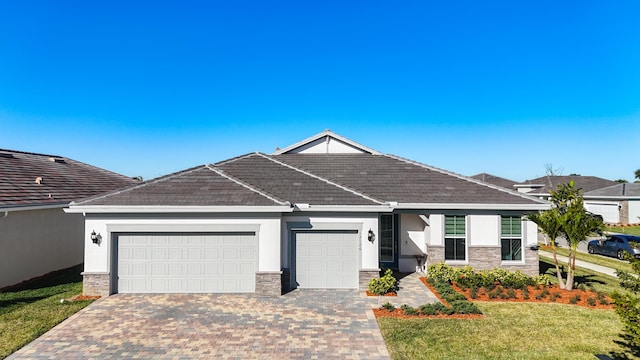 view of front of property with a garage and a front lawn