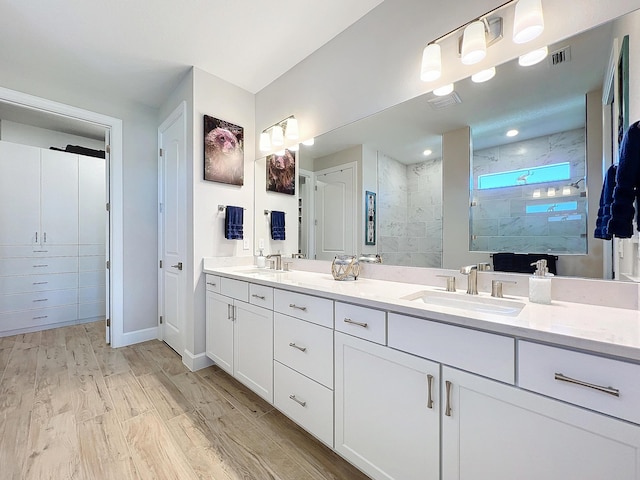 bathroom featuring an enclosed shower, vanity, and hardwood / wood-style flooring