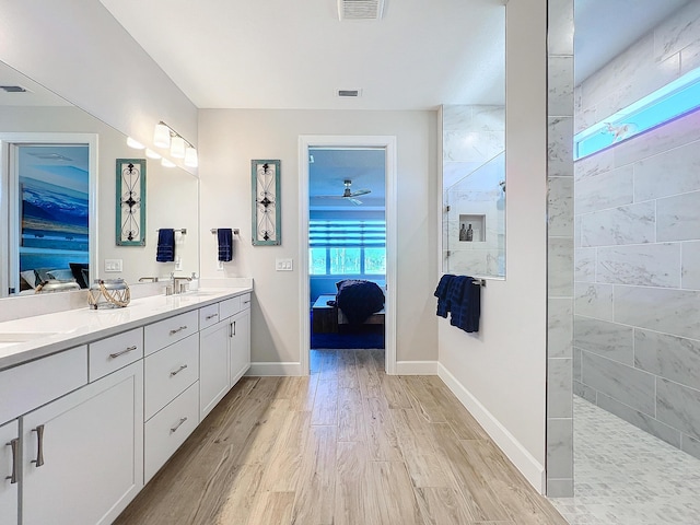 bathroom featuring hardwood / wood-style flooring, vanity, and walk in shower