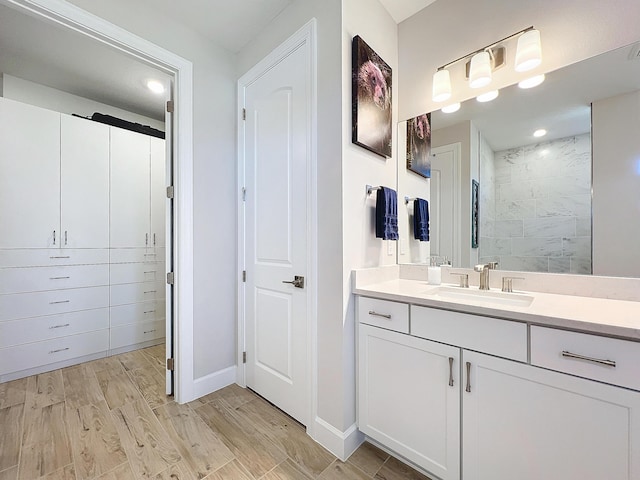 bathroom featuring vanity, a shower, and hardwood / wood-style floors