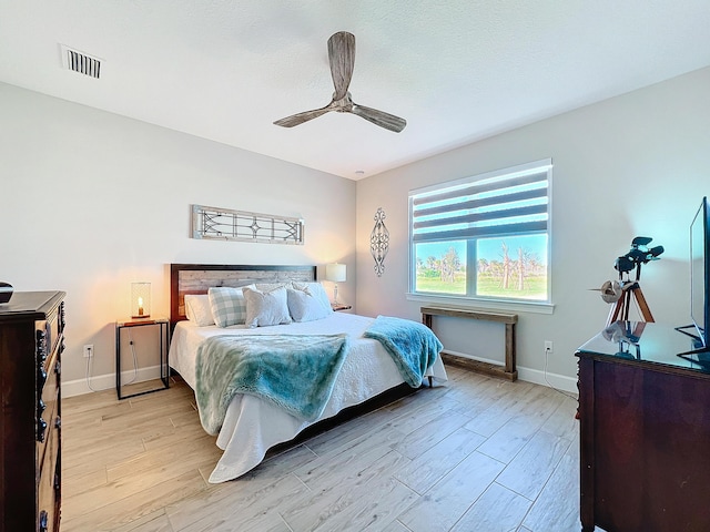 bedroom featuring ceiling fan and light hardwood / wood-style flooring