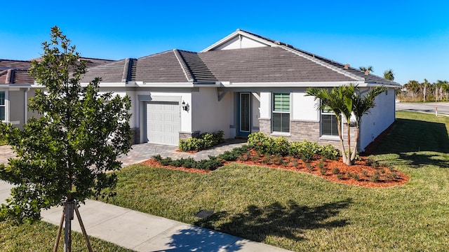 view of front of house featuring a garage and a front lawn