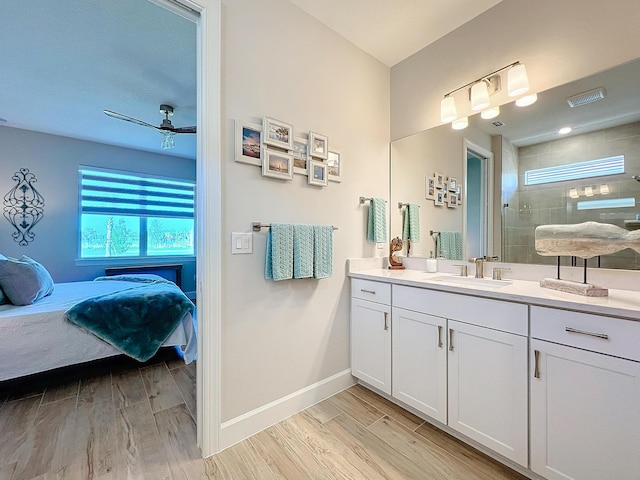 bathroom featuring vanity, ceiling fan, and walk in shower