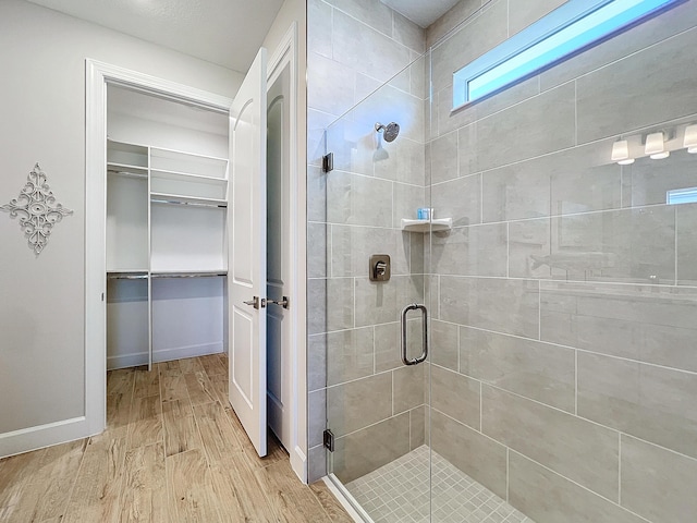 bathroom with hardwood / wood-style floors and walk in shower