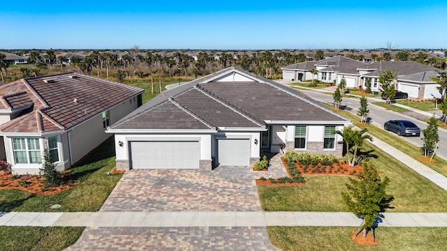 view of front of home with a garage and a front lawn