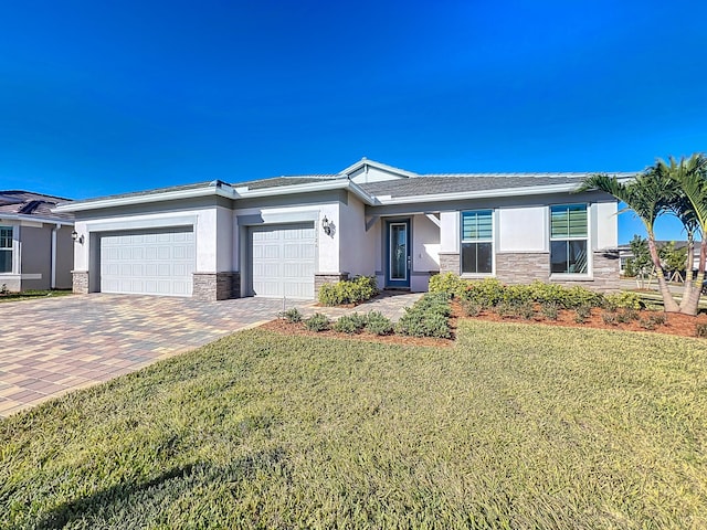 view of front of property with a garage and a front lawn