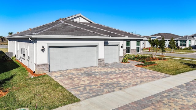 view of front of home featuring a garage and a front lawn