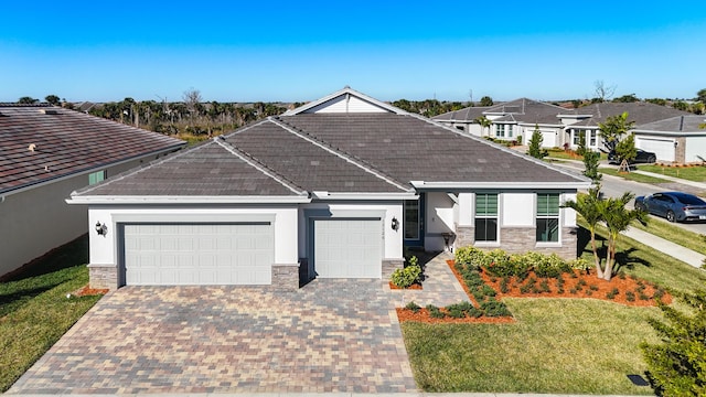 view of front of house featuring a garage and a front lawn