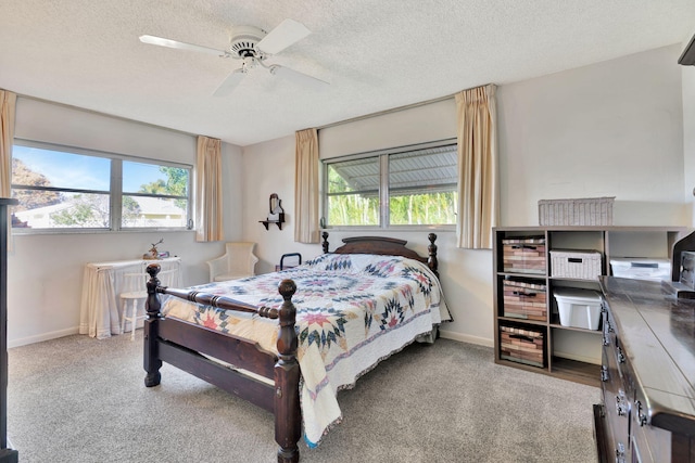 bedroom with ceiling fan, light colored carpet, and a textured ceiling