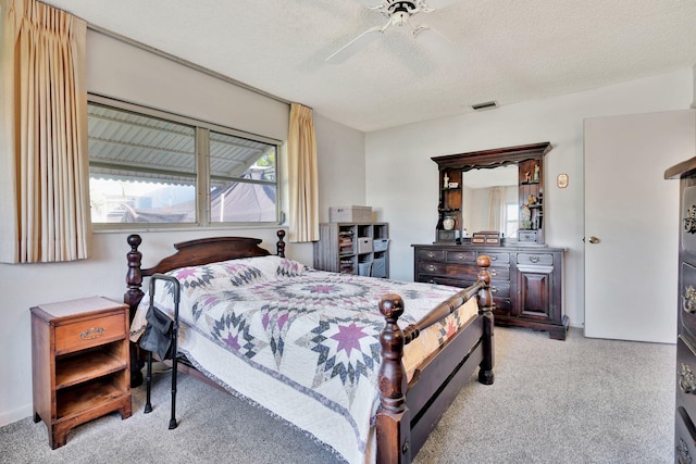 carpeted bedroom with multiple windows, a textured ceiling, and ceiling fan