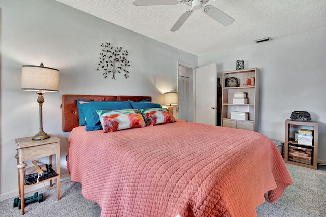 carpeted bedroom featuring a textured ceiling, a closet, and ceiling fan