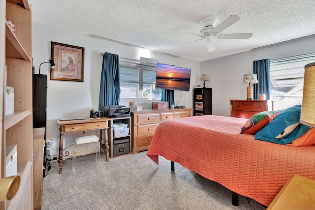 bedroom featuring ceiling fan and a textured ceiling