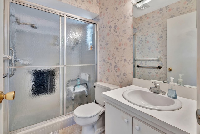 bathroom with toilet, vanity, tile patterned floors, and a shower with door