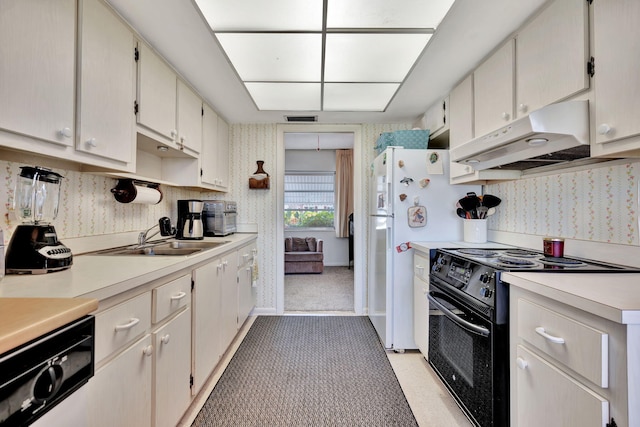 kitchen with white cabinetry, sink, and black range with electric cooktop