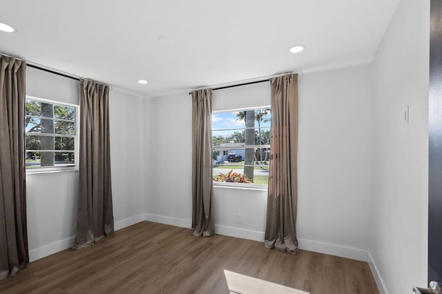 unfurnished room with hardwood / wood-style floors