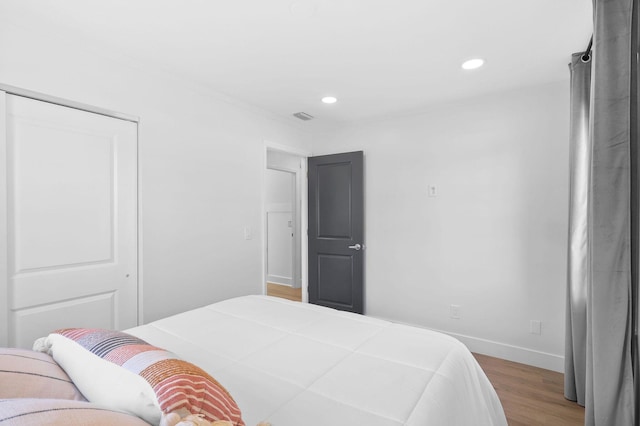 bedroom with a closet and dark hardwood / wood-style flooring