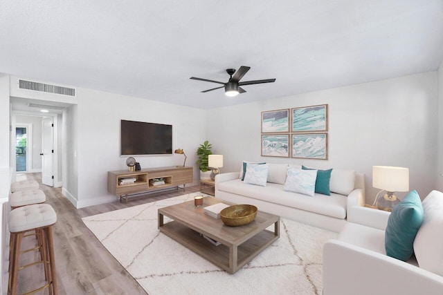 living room with ceiling fan and light wood-type flooring