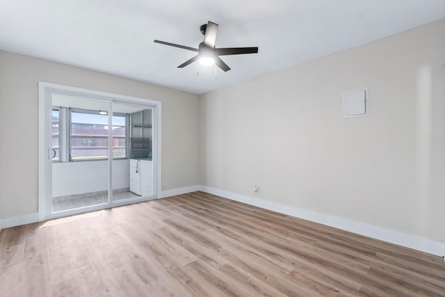 spare room with ceiling fan and light hardwood / wood-style flooring